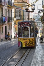 Funicular railway, yellow tram, Elevador da Bica, national monument, old residential buildings,