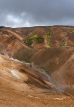 Steaming stream between colourful rhyolite mountains, Hveradalir geothermal area, Kerlingarfjöll,