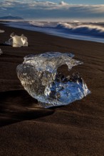 Ice floes on the beach in the evening light, sea, Breidamerkursandur, Jökulsarlon, south-east