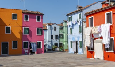 Colourful houses with washing lines, colourful house facades, alleyways on the island of Burano,