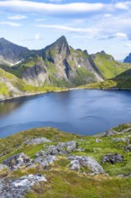 Mountain landscape with lake Tennesvatnet and rocky pointed mountain peak, at sunrise, Moskenesøya,