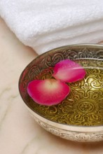 Bowl with massage oil and rose petals, massage oil, rose petals, oil, rose petals