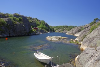 Small boat and bathing jetty in the rocky archipelago, holiday, travel, Bohuslän, Sweden, Europe