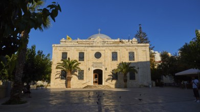 Agios Titos Church, facade, forecourt, palm trees, blue cloudless sky, city centre, old town,