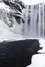 Skogafoss waterfall, snowy and icy rock face, Sudurland, Iceland, Europe