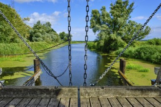 Picturesque river landscape, view from the heritage-protected wooden bascule bridge over the Trebel