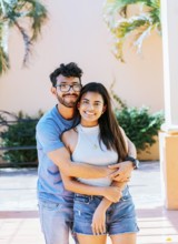 Portrait of a happy couple man hugging his girlfriend from behind, Portrait of a young couple man