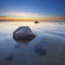 Large boulders on the beach of the Baltic Sea at sunset, Wismar Bay, Baltic Sea,