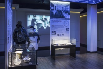 Visitors looking at film and findings brought back up from the Titanic wreck at the Cité de la Mer,