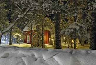 Old church in Jokkmokk in winter, red wooden building, snow-covered trees, Lapland, Sweden, Europe