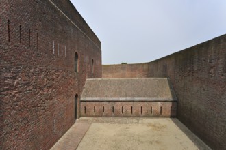 The pentagonal Fort Napoleon with caponier with gun ports and dry ditch in the dunes near Ostend,