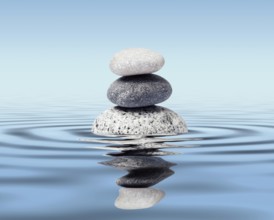 Zen stones in water with reflection, peace balance meditation relaxation concept