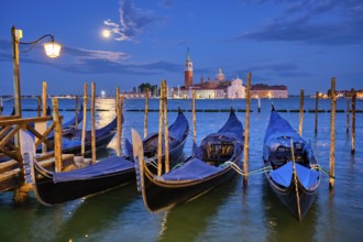 Romantic vacation Venice travel background, gondolas at Saint Mark (San Marco) square and Basilica