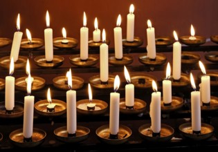 Offering candles in a church, Germany, Europe