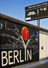 Mural entitled Berlyn on a remnant of the Berlin Wall, artist Gerhard Lahr, with advertising, East