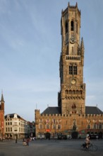 BRUGES, BELGIUM, MAY 28, 2018: Belfry tower famous tourist destination and Grote markt square in