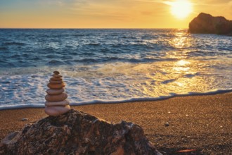 Concept of balance and harmony. Cairn stack of stones pebbles cairn on the beach coast of the sea