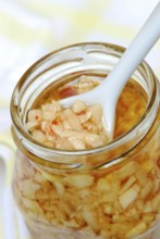 Aglio e Olio, pasta sauce from garlic, olive oil, and peperoncino in glass, chillies, Mediterranean