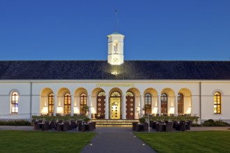 Illuminated Conversationshaus with spa garden in the evening, Norderney Island, Lower Saxony,