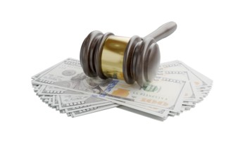 Gavel resting on stacks of thousands of dollars isolated on a white background