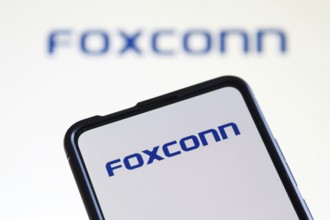 Foxconn logo of the computer manufacturer on a mobile phone and screen