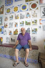 Tile painter in front of his tiles, Salvador, State of Bahia, Brazil, South America