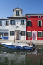 Colourful houses on the canal with reflection, Canal with boats and colourful house facades, Burano