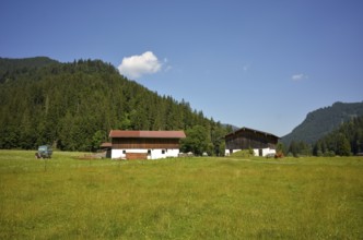 Traditional farm with tractor on the Rötelmoosalm in the Chiemgau, Bavaria, Germany, Europe