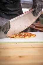 Pizza cutter with pizza, Calw, Black Forest, Germany, Europe