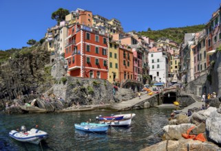 Fishing boats in the harbour of Riomaggiore, village view, Cinque Terre, province of La Spezia,