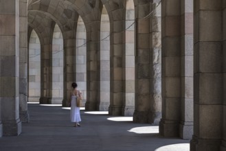 Lady in a white dress in the arcade of the Congress Hall, unfinished National Socialist monumental