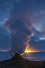 Mud pot with steam source at sunrise, Hverir solfataras field, fumaroles, snow-covered geothermal