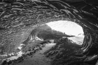 Filigree ice honeycombs at the entrance to the Pröng ice cave, black and white photo, Sudurland,