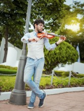 Man playing violin in the street. Portrait of man playing violin in the street. Jacket artist