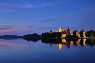 Evening view of Trakai Island Castle in lake Galve illuminated in the night reflecting in peaceful