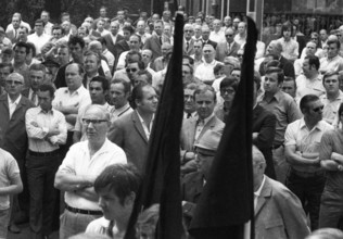 With black flags, mourning and anger, workers of Delog, a factory for flat glass, demonstrated in