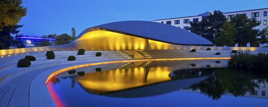 Illuminated Porsche Pavilion in the evening, Autostadt, Volkswagen AG, Wolfsburg, Lower Saxony,