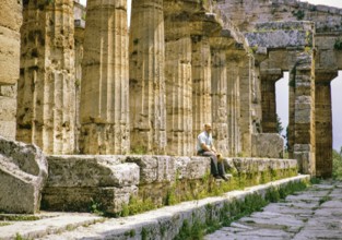 Man sitting inside Temple of Hera II, also known as the Temple of Neptune, Paestum archaeological