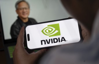 In this photo illustration, the Nvidia Corporation logo is displayed on an iPhone screen in front