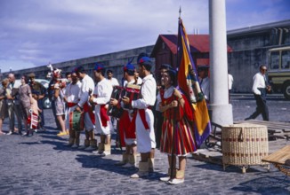 Folk musicians in traditional costume line up to greet cruise ship visitors, 1969, Funchal, Medeira