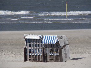 Two empty beach chairs in front of an undulating sea, spiekeroog, east frisia, north sea, germany