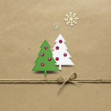 Creative concept photo of paper Christmas trees on a brown background