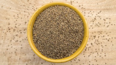 Carom Seeds, Thymol Seeds, Bishop's Weed, Ajwain in a Yellow Bowl, Flat Lay