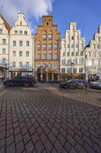 Historic houses, restaurants, facades with windows and gables, street An der Obertrave, Hanseatic