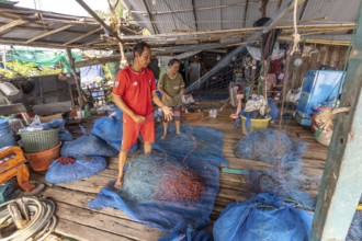 Fishermen repairing their nets, Ban Ao Salad fishing village, Ko Kut island or Koh Kood island in