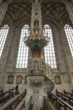 Pulpit with sandstone staircase in the late Gothic hall church of St George, Dinkelsbühl, Bavaria,