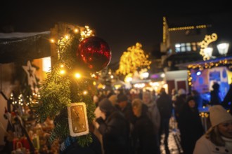 Festive Christmas decorations with lights and people at a Christmas market at night, Christmas