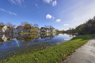 Riverbank of the Trave at high tide, blue sky with cumulus clouds, old town, Hanseatic city of