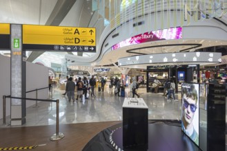 Abu Dhabi Airport, Zayed International Airport with passengers. Duty free shop. The new Terminal A