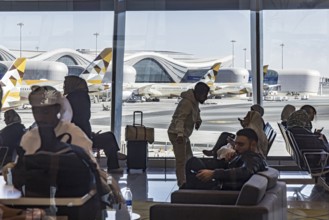 Abu Dhabi Airport. View of the modern terminal with Etihad airline aircraft from the gate. Abu